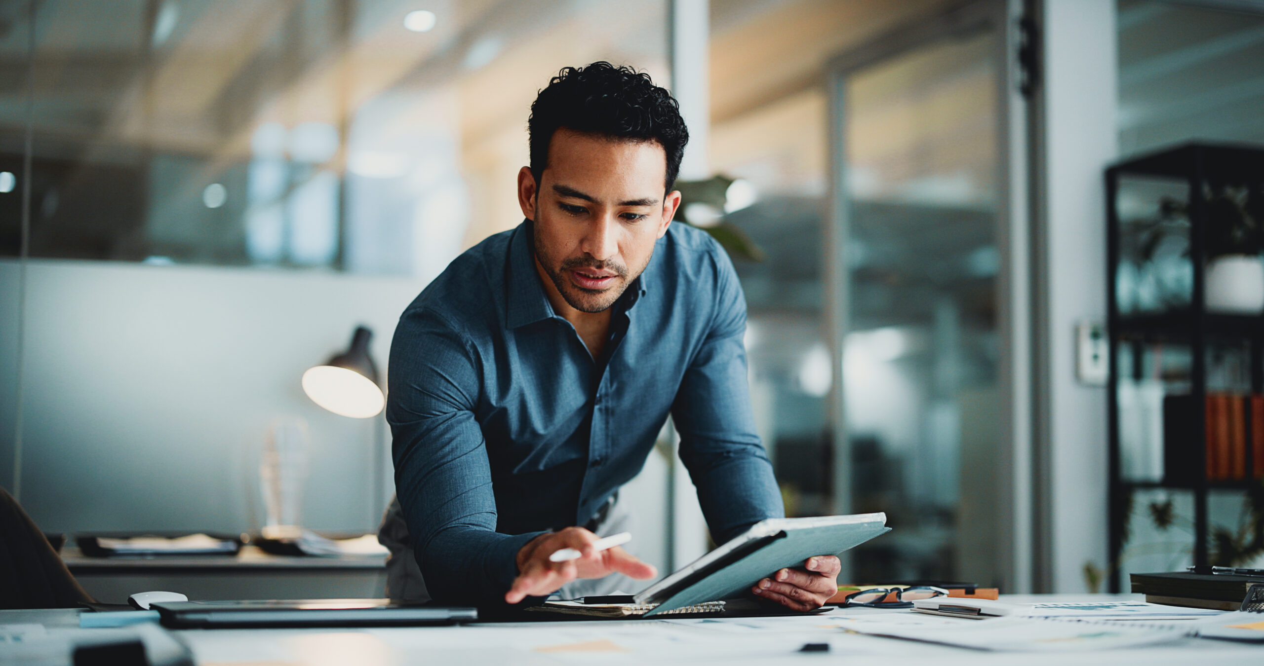 High-functioning alcoholic executive reviewing work on a tablet